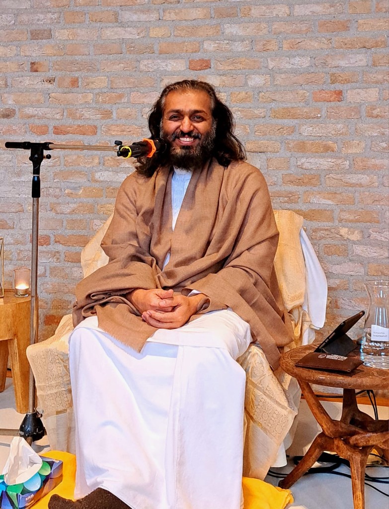 Swami Divyatej seated during a gathering